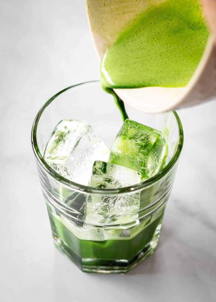Chinese matcha being poured over ice in a glass