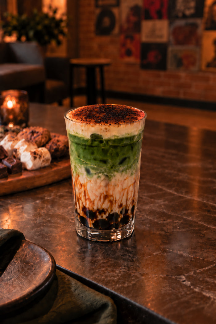 Layered matcha boba with brown sugar tapioca pearls, creamy milk, and a caramelised crème brûlée topping.